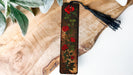 a piece of wood with a painting of roses on it