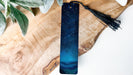 a blue tie with a tassel hanging from it