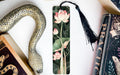 a bookmark with a snake and flowers on it