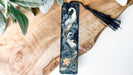 a black and white bookmark with a swan on it