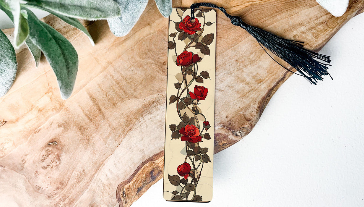 a bookmark decorated with red roses and a tassel