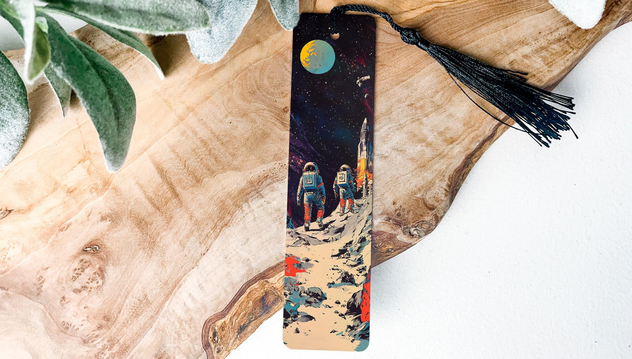 a wooden bookmark with a painting of a space scene on it