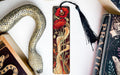 a snake, a bookmark, and some books on a table