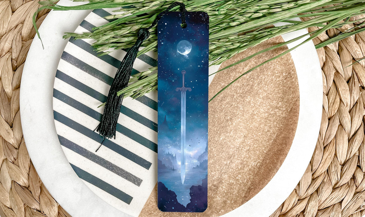 a bookmark sitting on top of a plate next to a plant