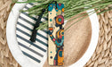 a wooden bookmark sitting on top of a white plate