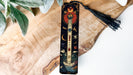 a wooden object with a tassel on top of it