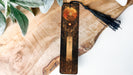 a wooden cross with a tassel hanging from it