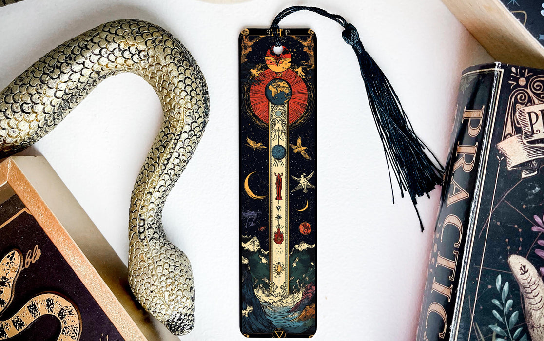 a bookmark with a snake on it next to books