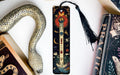 a bookmark with a snake on it next to books