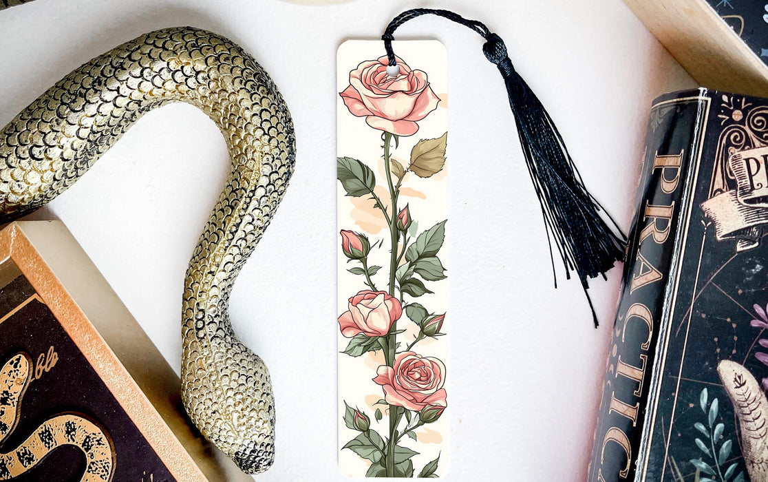 a bookmark with a snake and roses on it