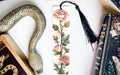 a bookmark with a snake and roses on it