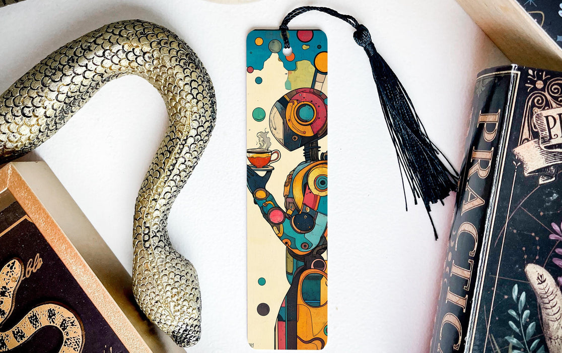 a bookmark with a snake on it next to books