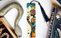 a bookmark with a snake on it next to books