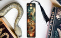 a bookmark with a snake and a book on it