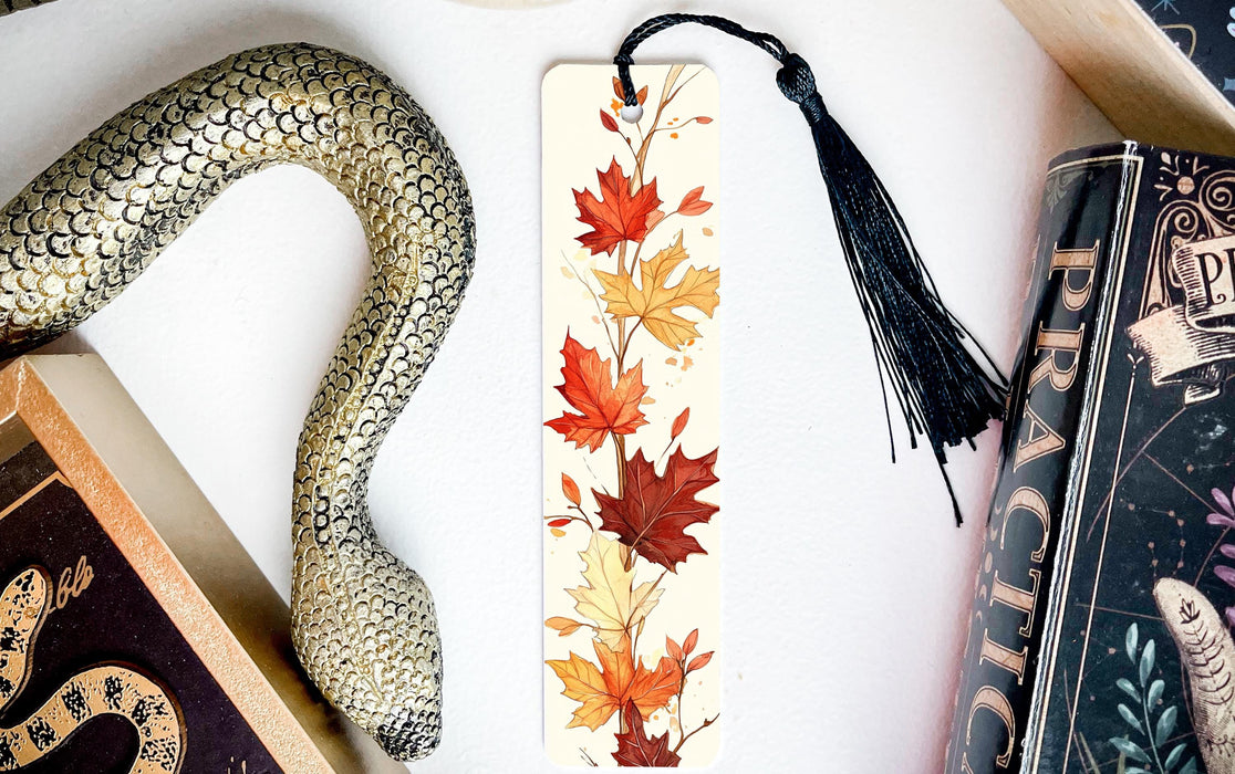 a bookmark with a snake and autumn leaves on it