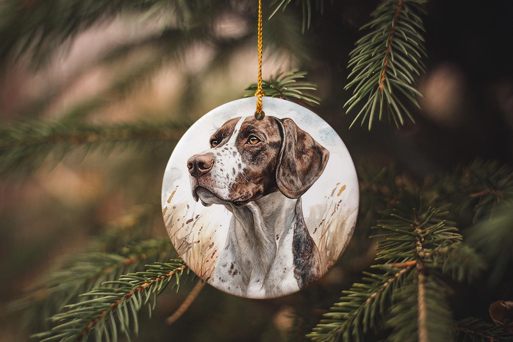 a brown and white dog ornament hanging from a tree