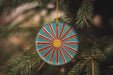 a christmas ornament hanging from a christmas tree