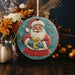 a christmas ornament with a santa clause holding a gift