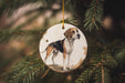 a dog ornament hanging from a christmas tree