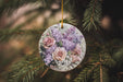 a floral ornament hanging from a christmas tree
