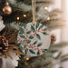 a ceramic ornament hanging from a christmas tree