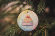 a ceramic ornament hanging from a christmas tree