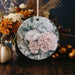 a ceramic ornament decorated with flowers and leaves