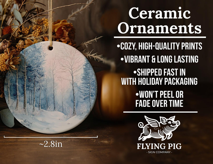 a ceramic ornament with a snowy forest scene