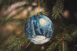 a christmas ornament hanging from a christmas tree