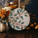 a ceramic ornament decorated with flowers and leaves
