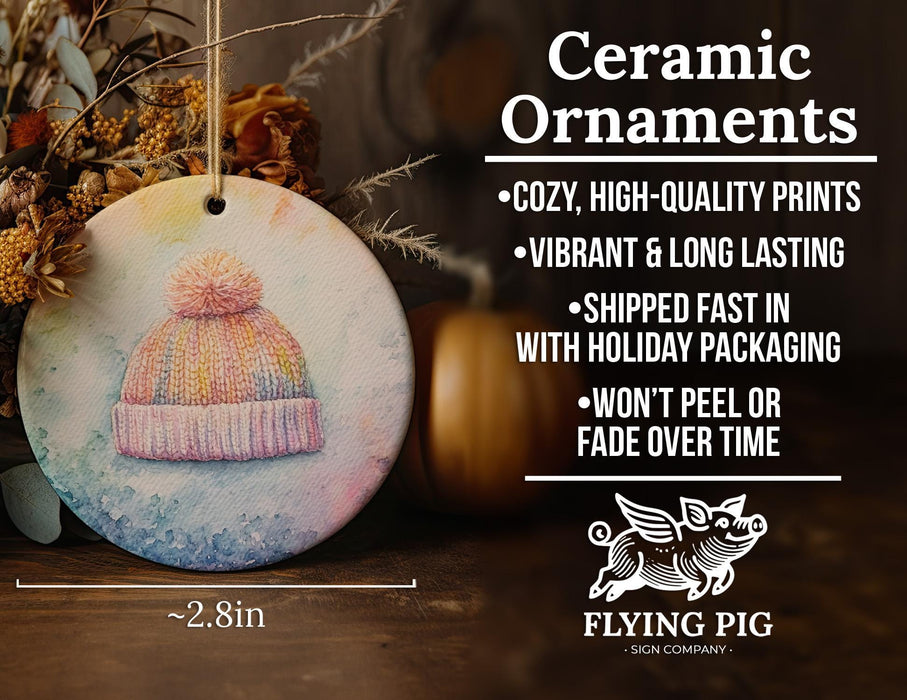 a ceramic ornament with a knitted hat on it