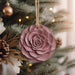 a pink ornament hanging from a christmas tree