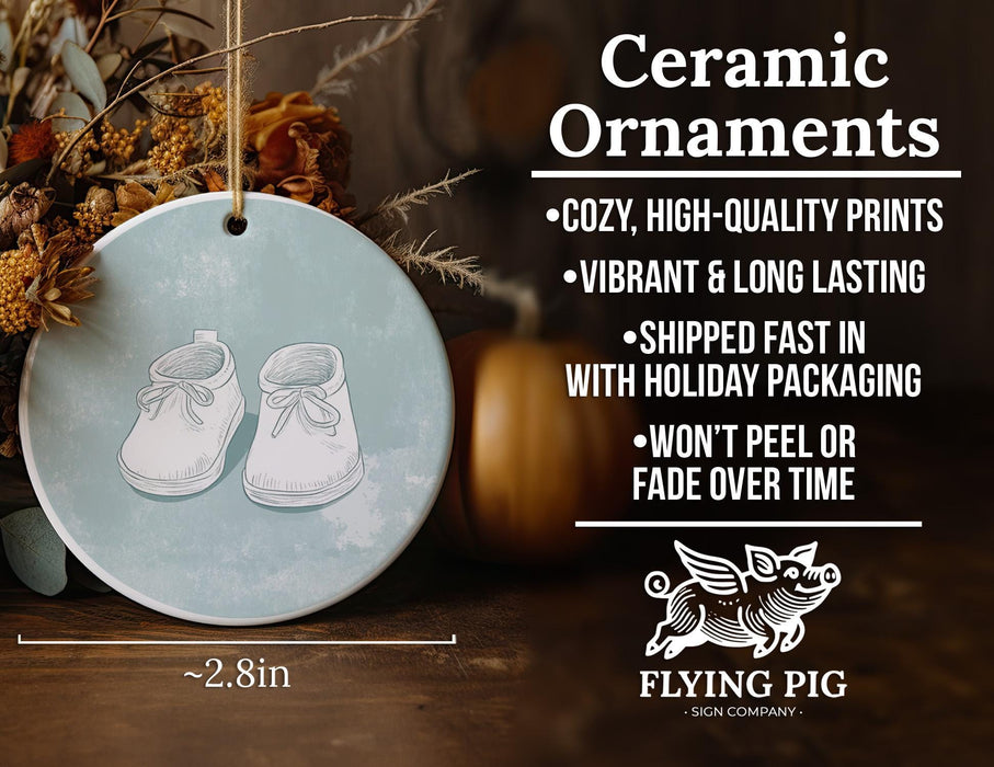 a ceramic ornament with a pair of baby shoes on it