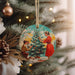 a christmas ornament hanging from a christmas tree