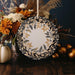 a white and gold plate sitting on top of a wooden table