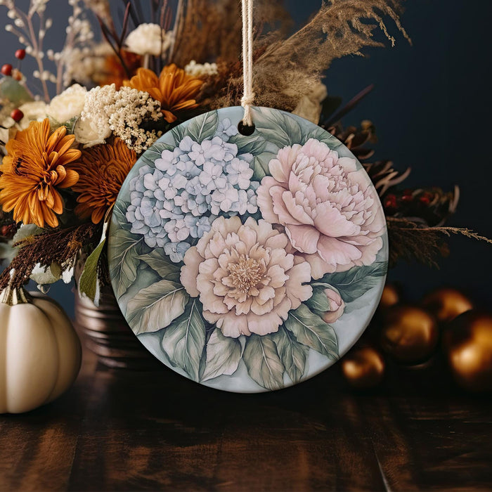 a ceramic ornament decorated with flowers and leaves