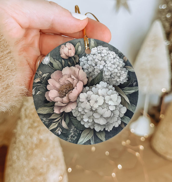 a person holding a flower ornament in their hand