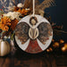 a wooden angel ornament sitting on top of a table