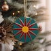 a christmas ornament hanging from a christmas tree