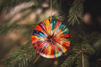 a colorful ornament hanging from a christmas tree