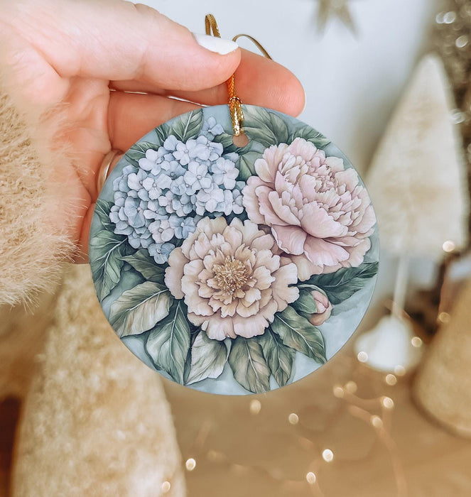 a person holding a flower ornament in their hand
