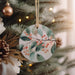 a ceramic ornament hanging from a christmas tree