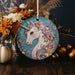 a ceramic ornament with a picture of a unicorn on it