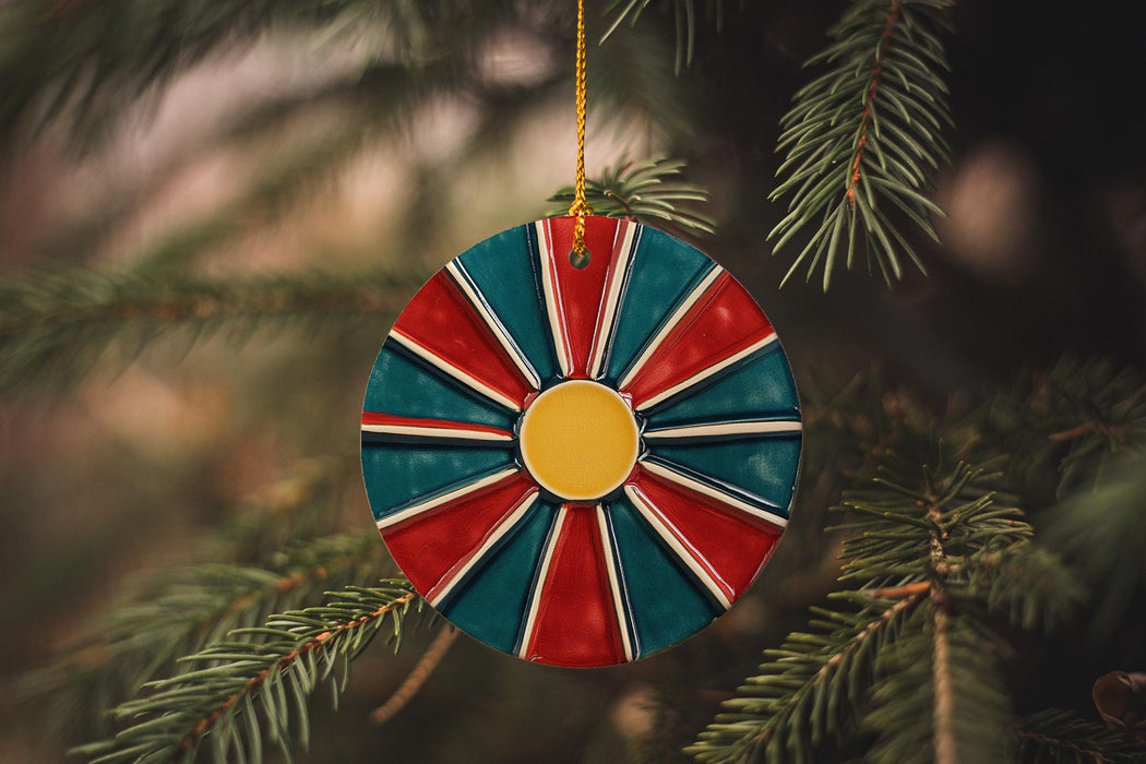 a red, white, and blue ornament hanging from a christmas tree