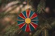 a red, white, and blue ornament hanging from a christmas tree