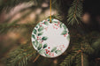 a ceramic ornament hanging from a christmas tree