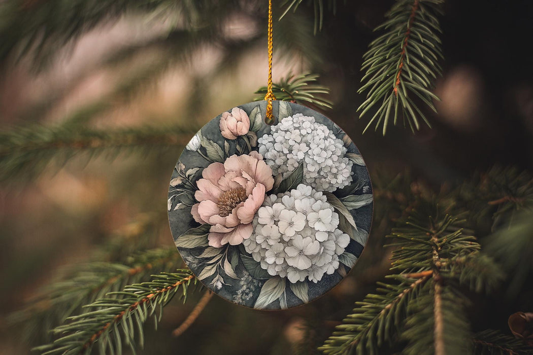 a christmas ornament with flowers hanging from a tree