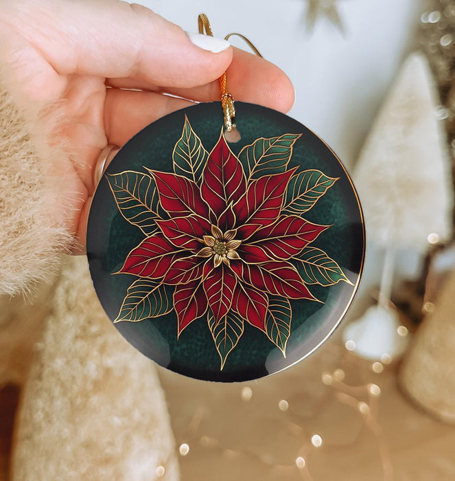 a person holding a christmas ornament in their hand