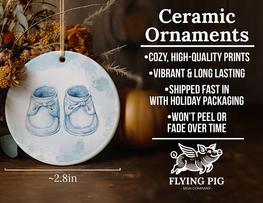a ceramic ornament with a pair of baby shoes on it