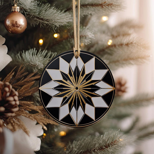 a black and white ornament hanging from a christmas tree